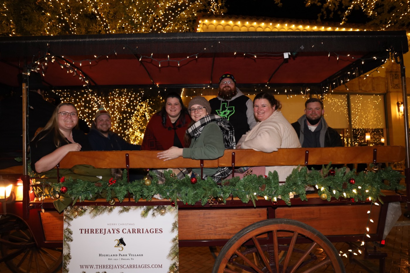 Guests riding a Threejays Carriages wagon at night